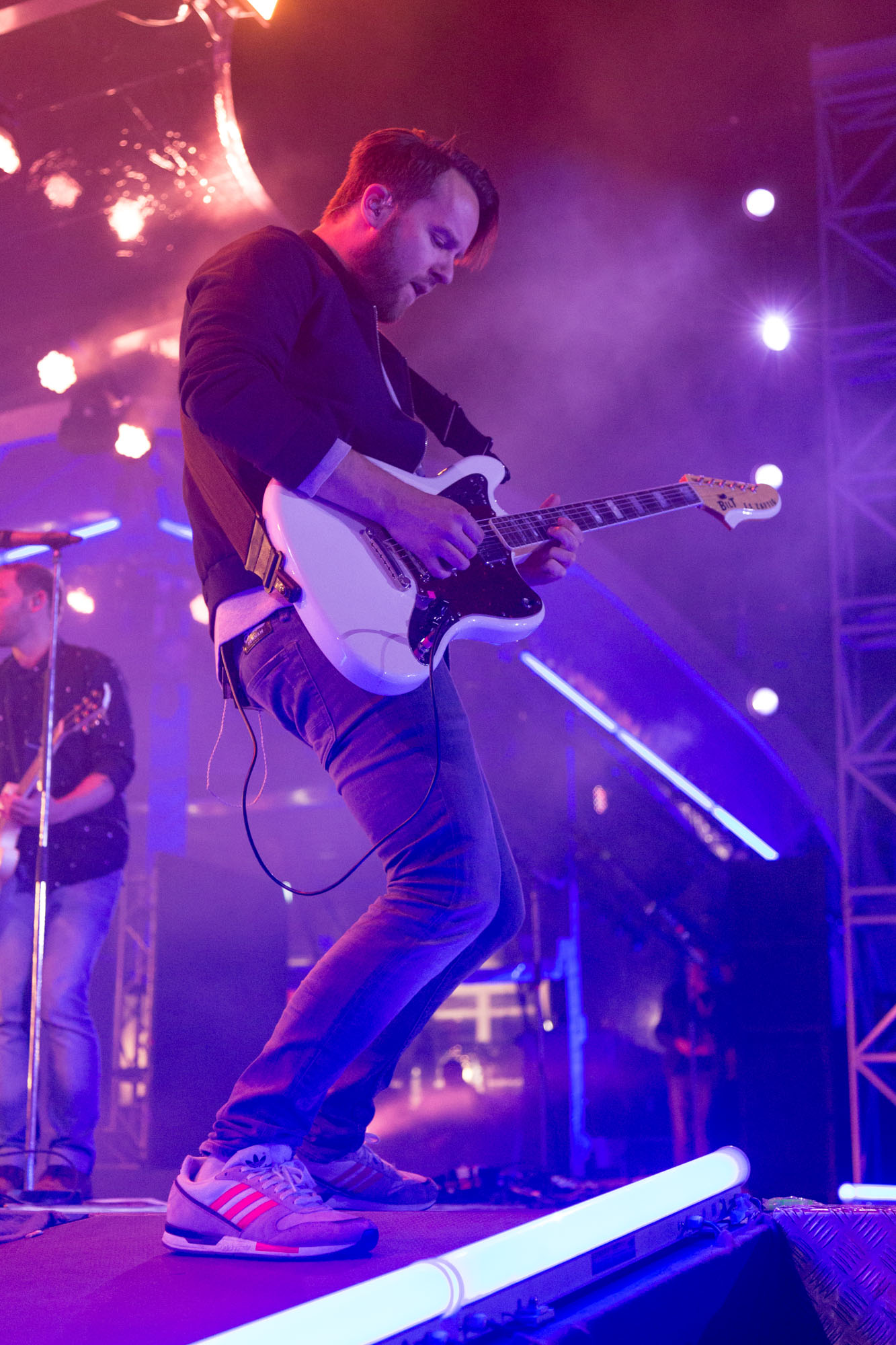 Gitarrist von Revolverheld in lila Lichtsetup